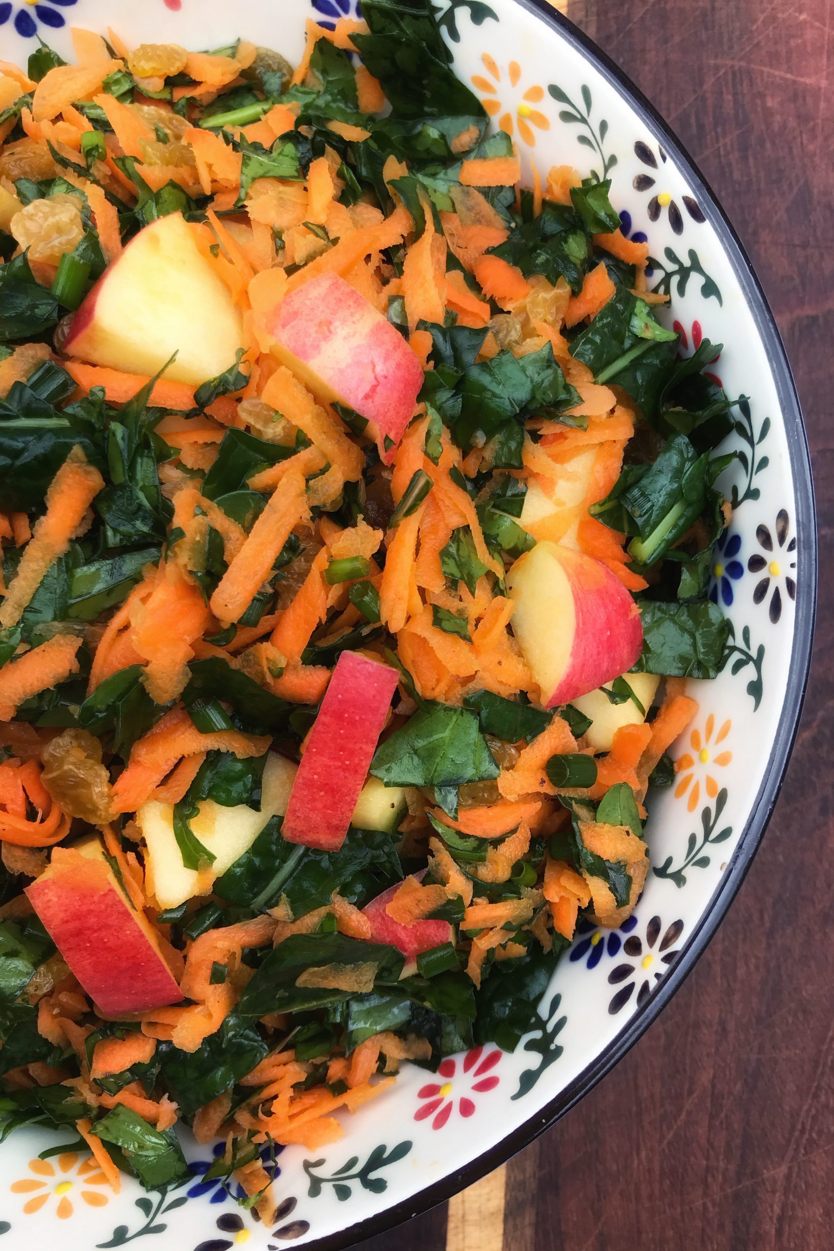 Kale Slaw with Apples, Carrots and Raisins in a bowl